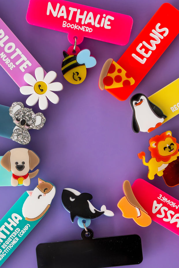 Colorful name tags with animal designs on a purple background